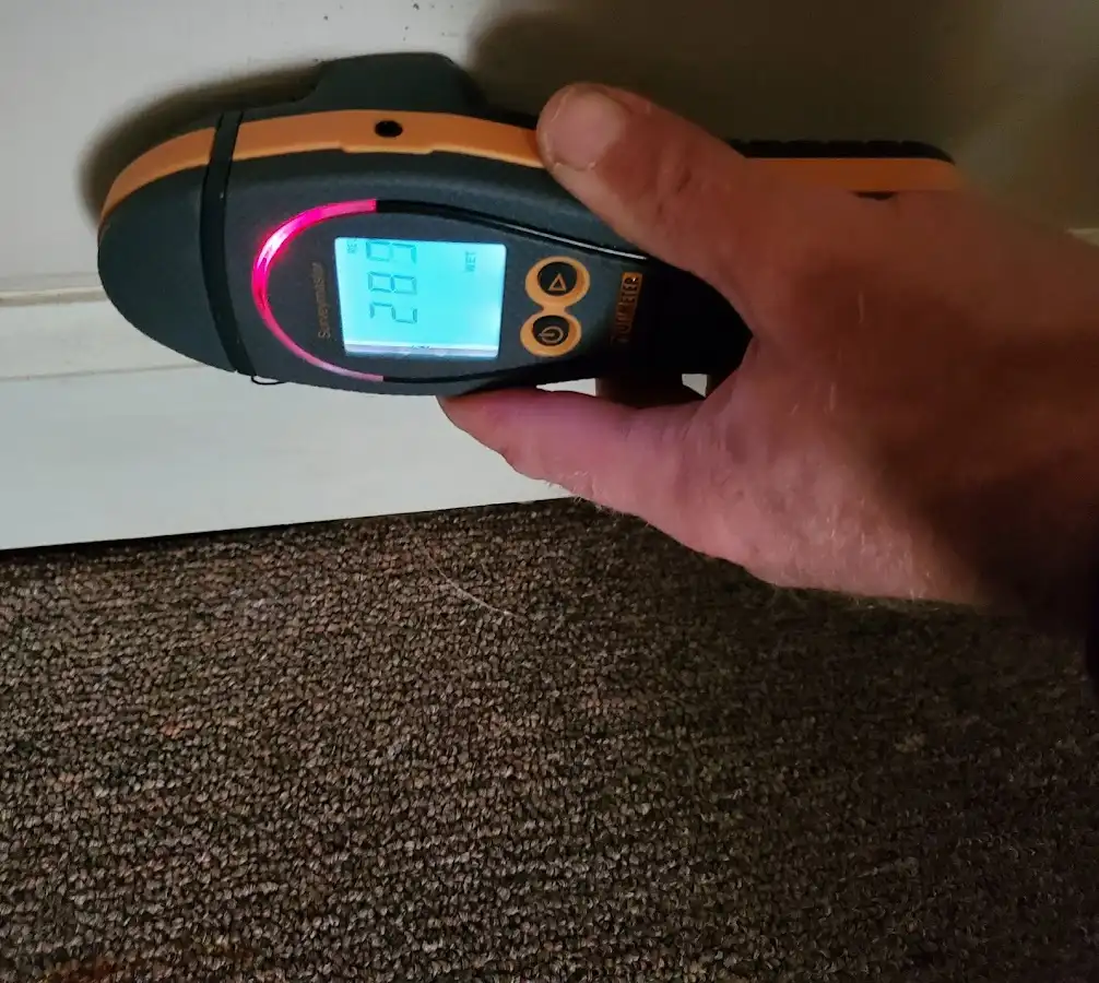 Moisture detection at baseboard during Storm Damage Restoration in Harpswell